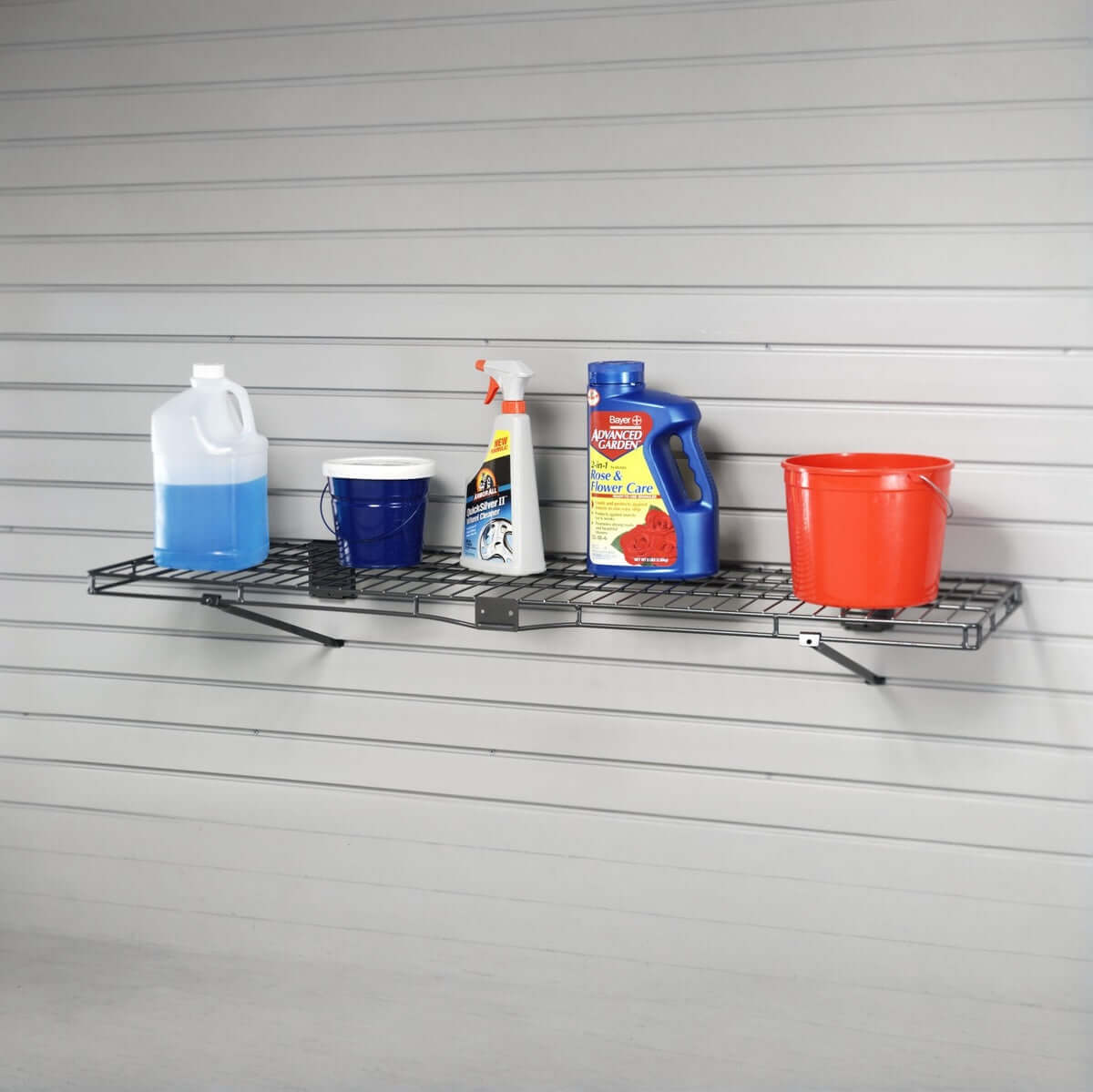 Slatwall Shelves holding garage supplies including cleaners, sprays, and buckets on a wall-mounted 14x48 inch wire shelf