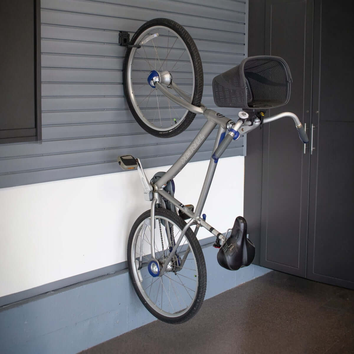 Slatwall Bike Rack hook holding a Trek bicycle vertically against a garage wall, saving floor space