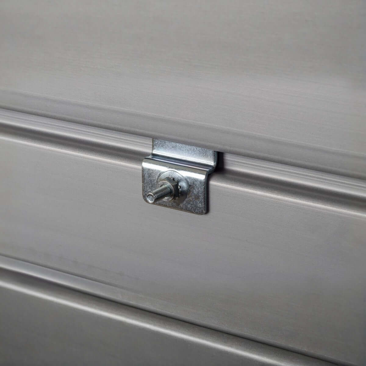 Slatwall Workshop Accessories light duty clip mounted on metal panel, showing bolt fastener detail for secure shelf attachment