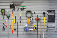 Slatwall Accessory Kits organizing garage tools, garden equipment, hose, cleaning supplies, and a ladder on a gray wall panel