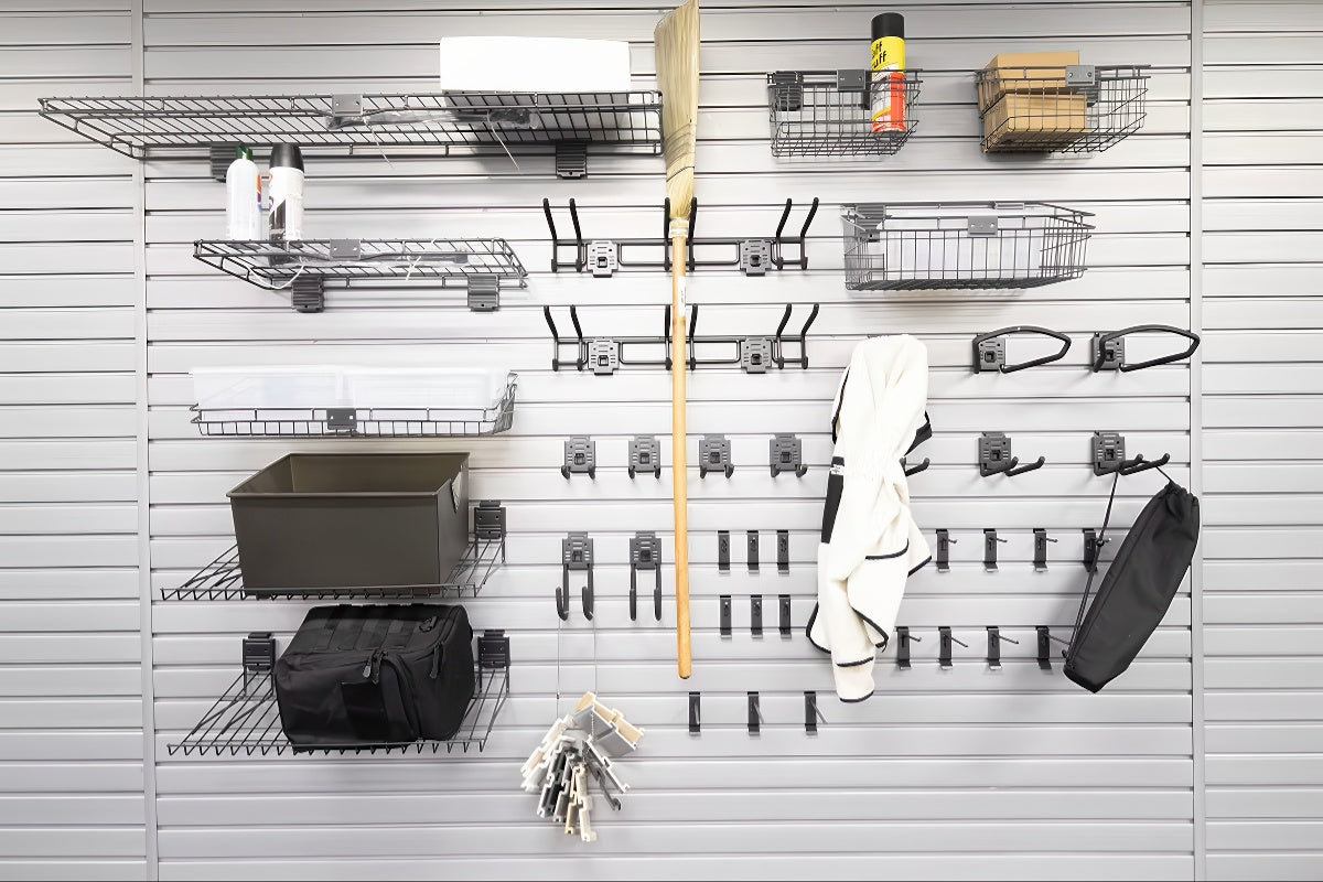 Slatwall Accessory Kits deluxe set with wire shelves, baskets, hooks, and bins organizing garage tools and bags on a slat wall panel