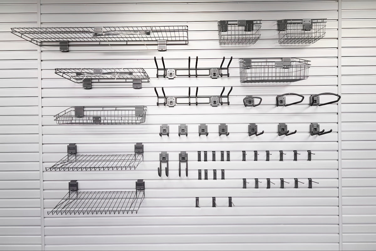 Slatwall Accessory Kits display featuring wire shelves, baskets, bike hooks, and various hanging hooks on white slat wall panel