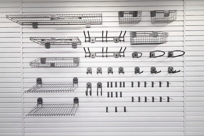 Slatwall Accessory Kits display featuring wire shelves, baskets, bike hooks, and various hanging hooks on white slat wall panel