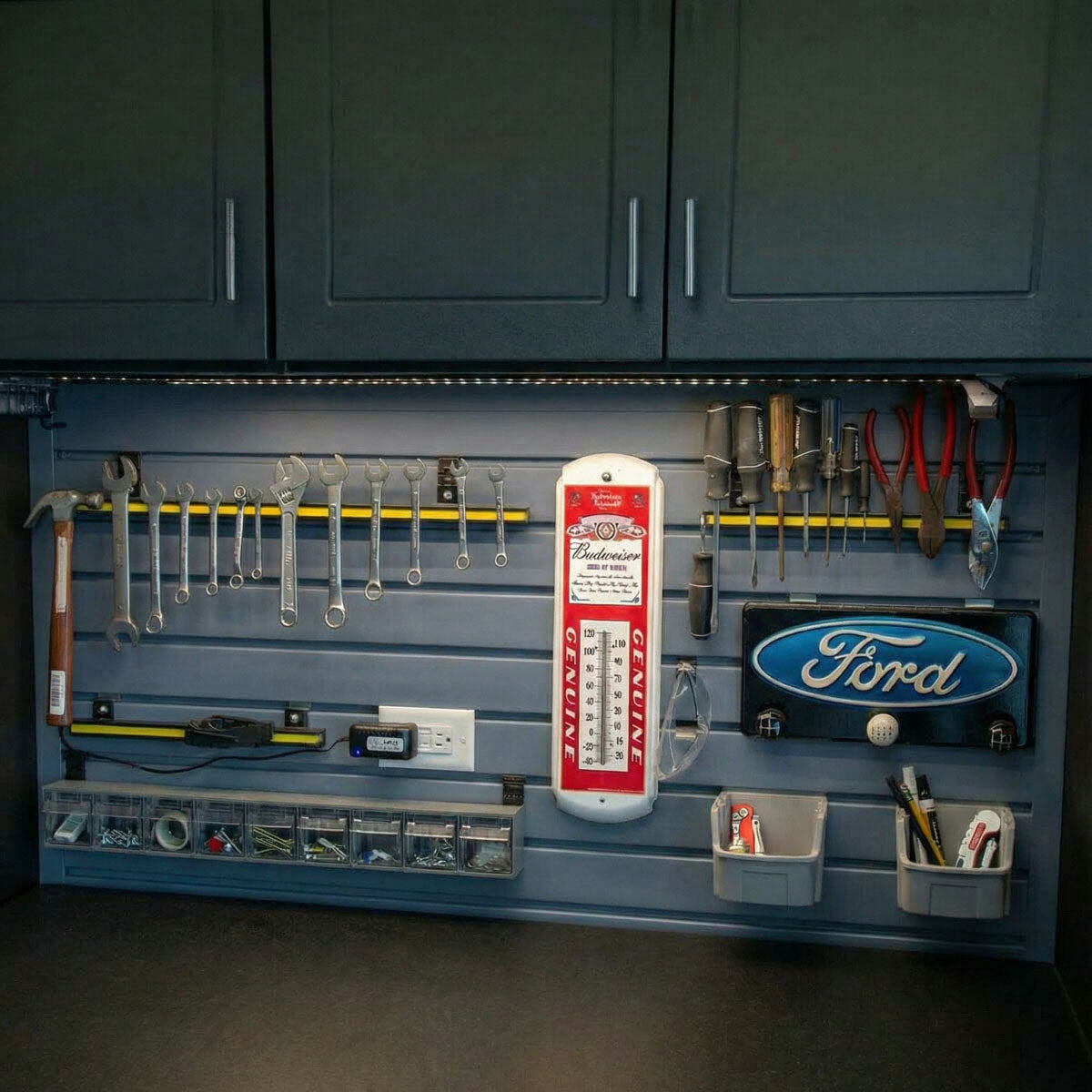Slatwall Panels organizing a garage wall with wrenches, screwdrivers, bins, and Ford and Budweiser dacor signs__DriftwoodSlate