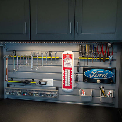 Slatwall Panels organizing a garage wall with wrenches, screwdrivers, bins, and Ford and Budweiser dacor__Gray