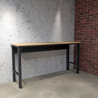 Standard Benches 72" garage workbench with wood top and black steel frame against concrete and brick wall__CharcoalGray
