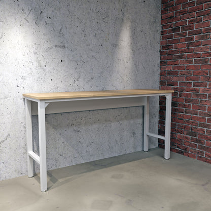 Standard Benches 72" garage workbench with wood top and white steel frame against concrete and brick wall__White