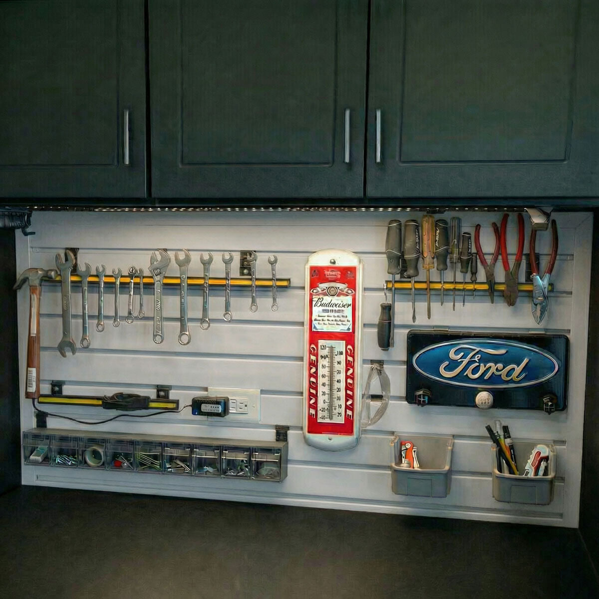 Slatwall Panels organizing a garage workshop with wrenches, screwdrivers, bins, and Ford and Budweiser dacor signs__White