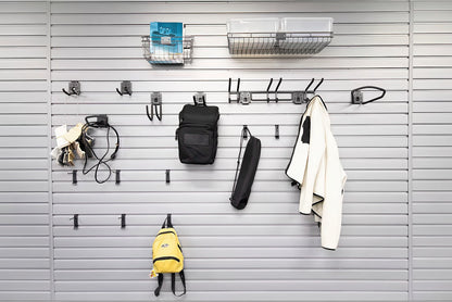 Slatwall Accessory Kits displayed on a gray wall panel holding backpacks, bags, a jacket, baskets, and various hooks