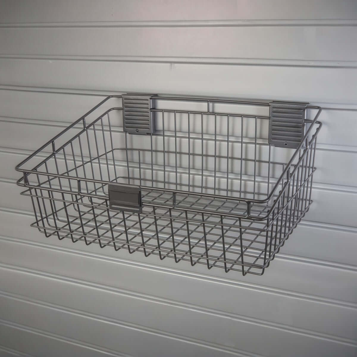 Slatwall Baskets - 12x18 inch silver wire basket mounted on white slatwall panel for garage storage organization