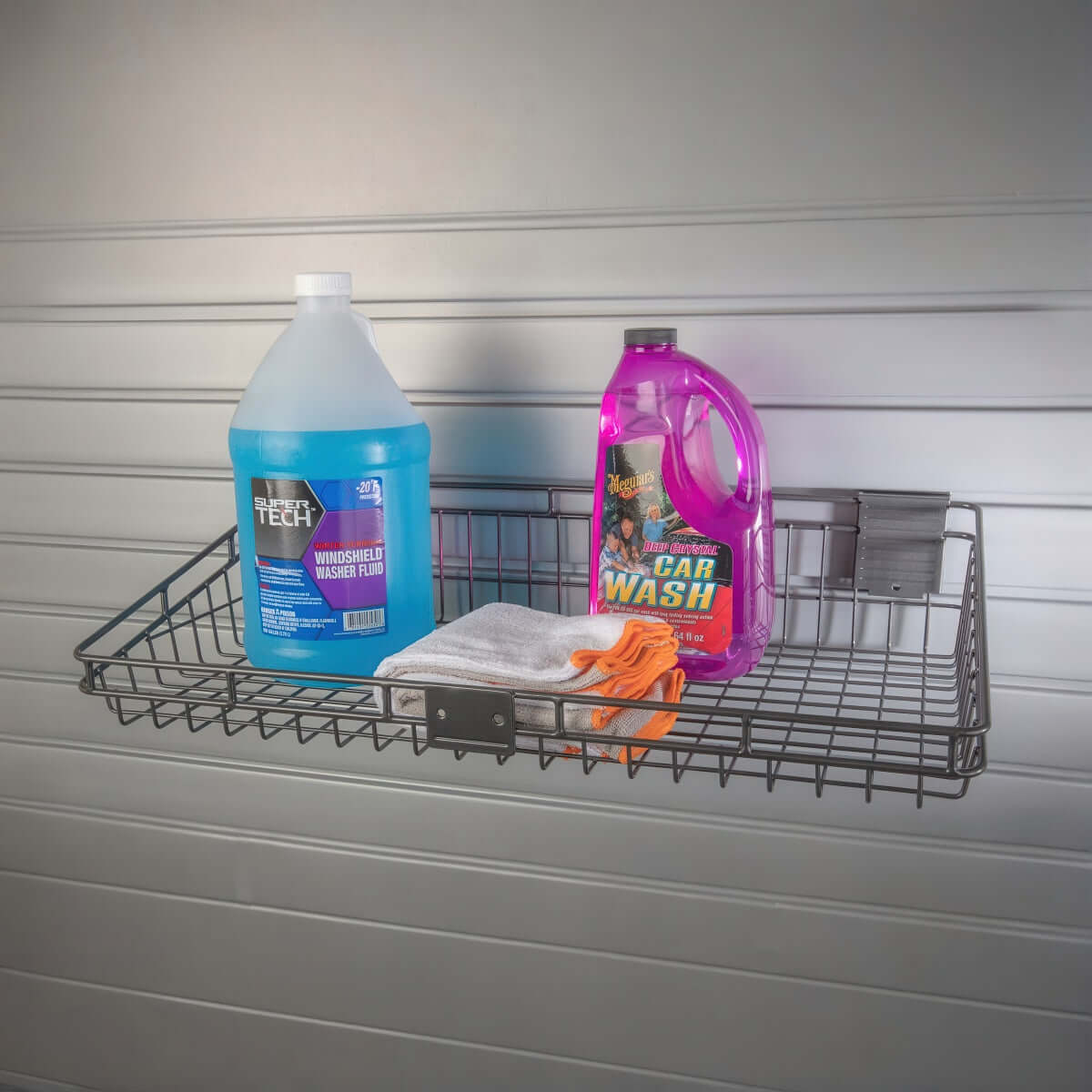 Slatwall Baskets wall-mounted shelf holding windshield washer fluid, car wash soap, and cleaning cloths in garage