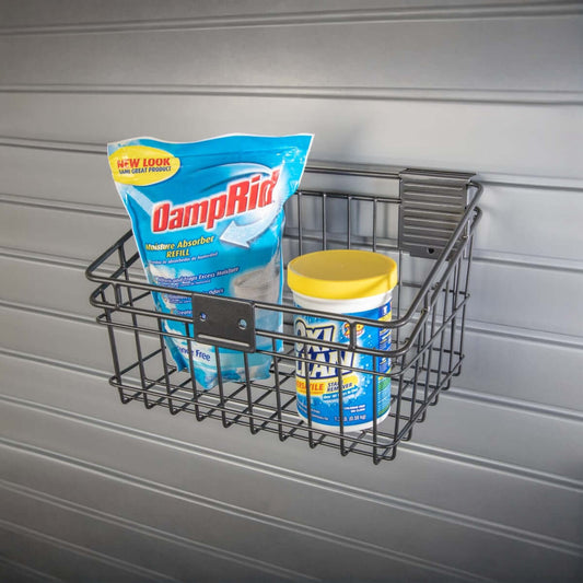 Slatwall Baskets wire shelf mounted on garage wall holding DampRid moisture absorber and OxiClean stain remover