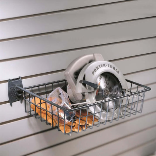 Slatwall Baskets wire shelf mounted on garage wall holding Porter-Cable circular saw, work gloves, and safety goggles