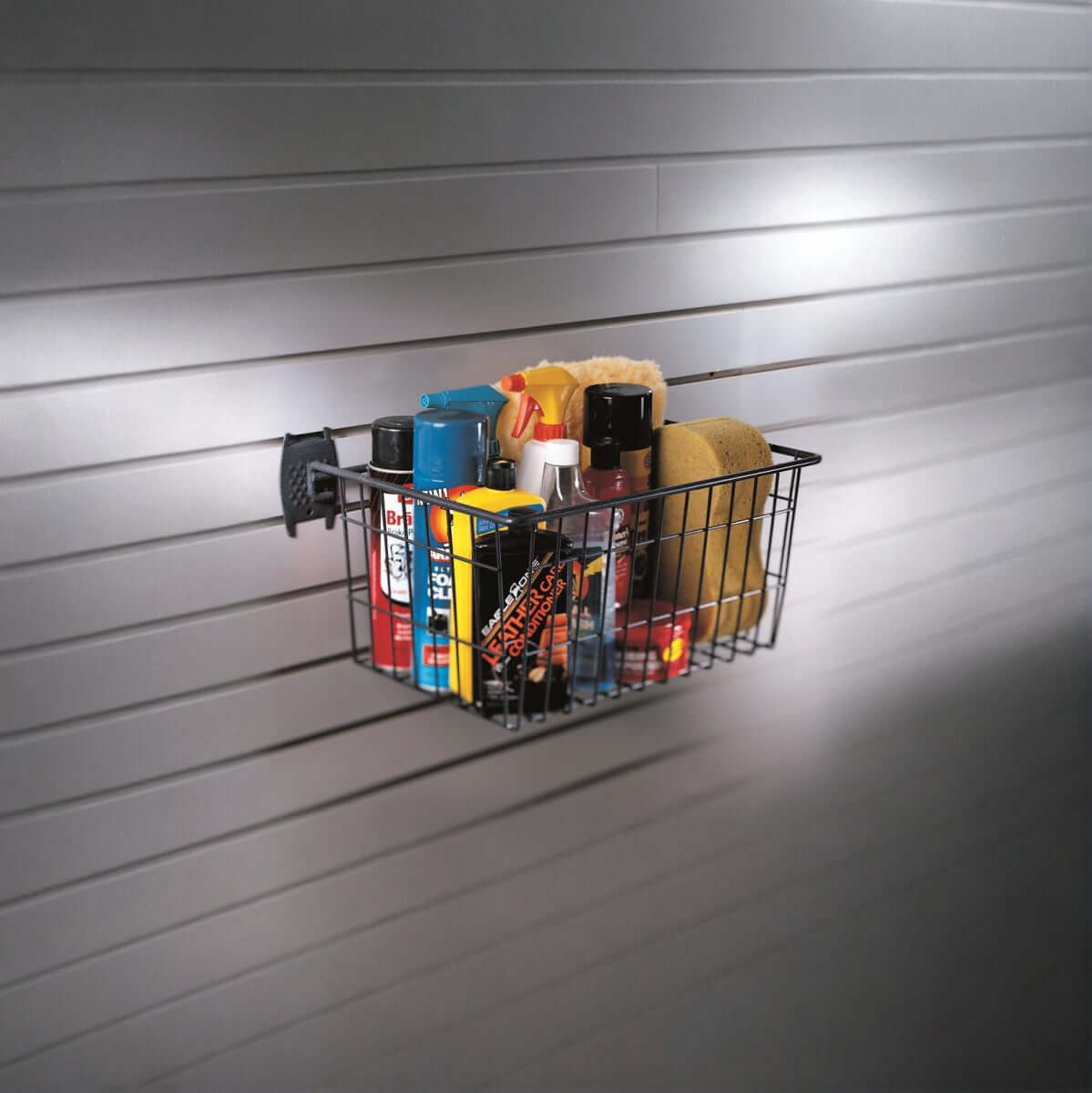 Slatwall Baskets wire storage basket mounted on garage wall holding car care products and cleaning supplies