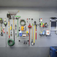 Slatwall Accessory Kits organizing garage tools, hoses, cleaning supplies, and a ladder on a gray slatwall panel system