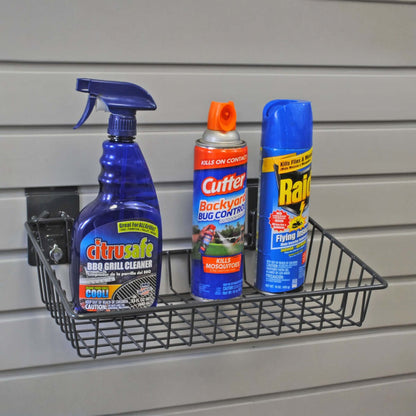 Slatwall Baskets angled wire shelf mounted on garage wall holding BBQ cleaner, Cutter bug spray, and Raid insecticide